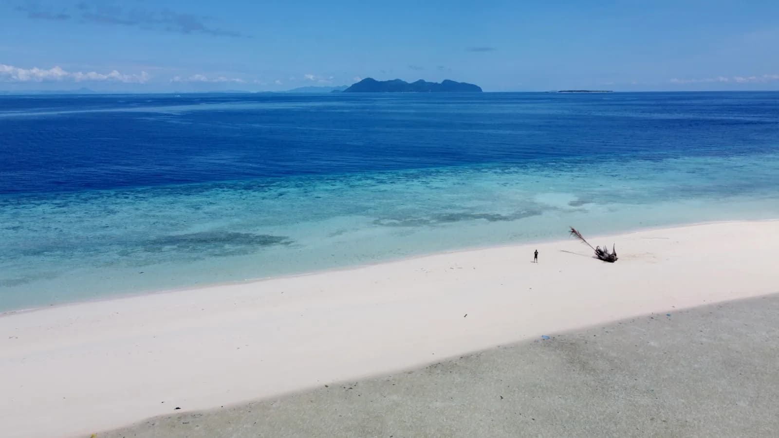 An aerial view of Redang Island with turquoise water and a reef