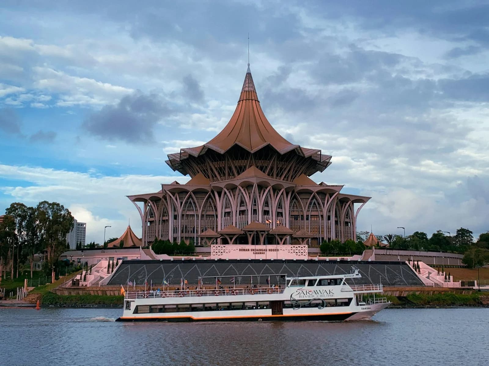 The Sarawak State Legislative Assembly and a river cruise boat on the Sarawak River in Kuching