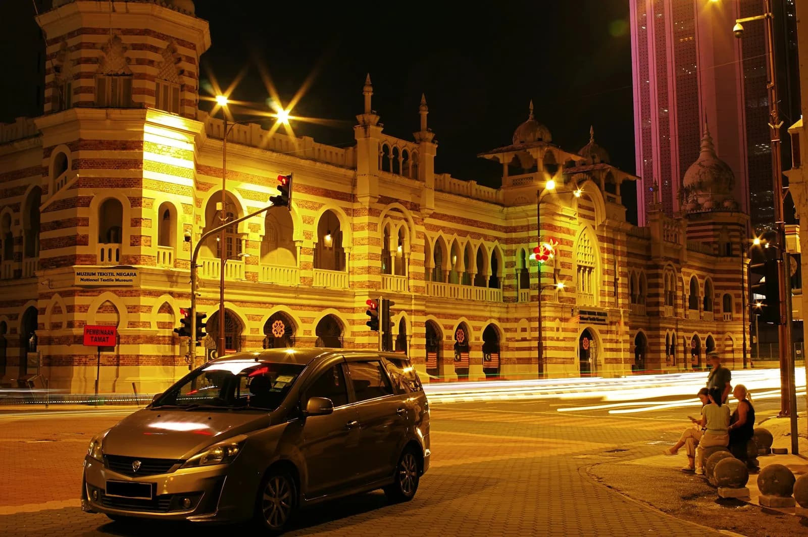 A private tour vehicle waiting on a Kuala Lumpur street