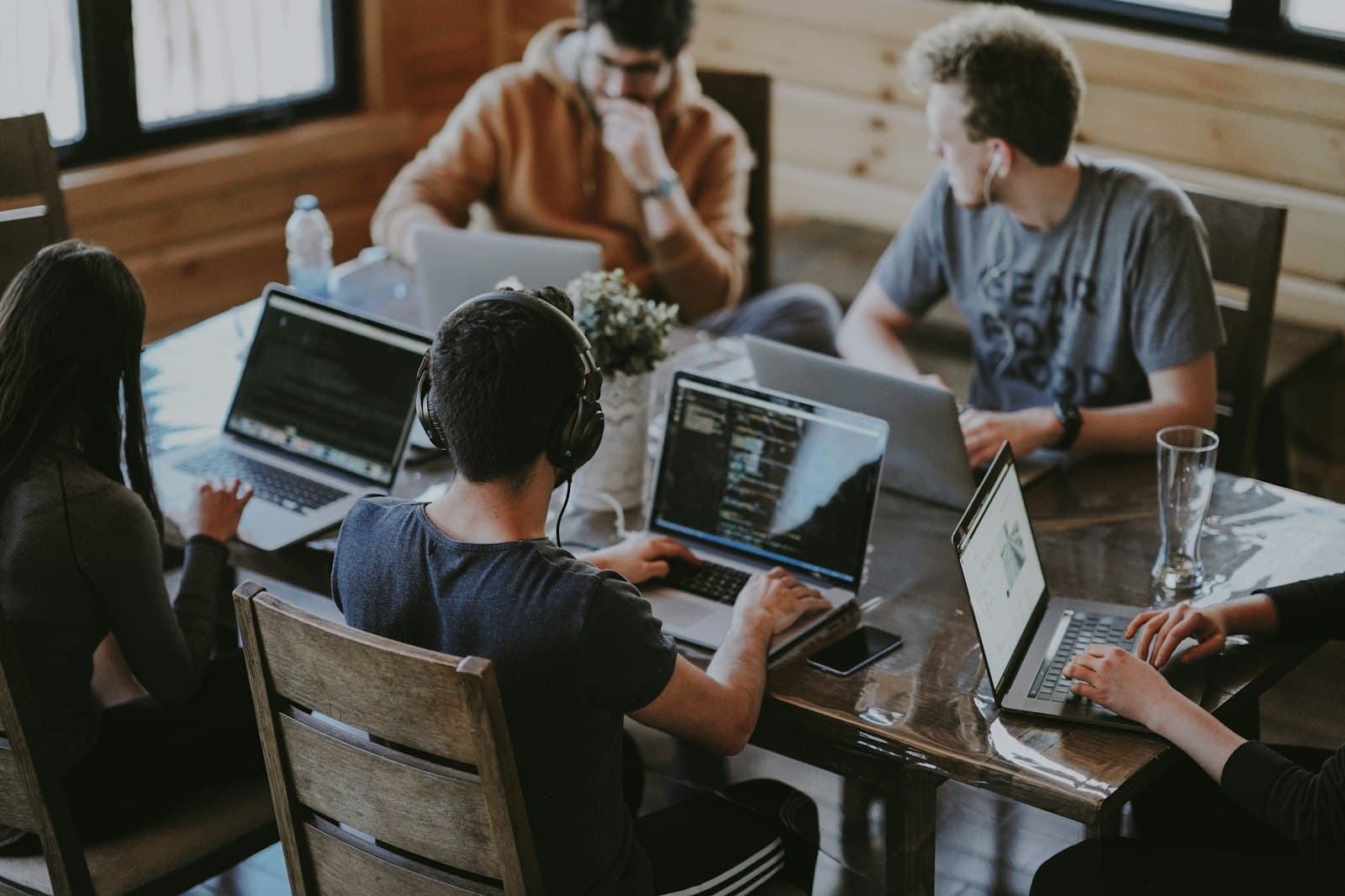 A team planning a Kuala Lumpur event at a table of laptops
