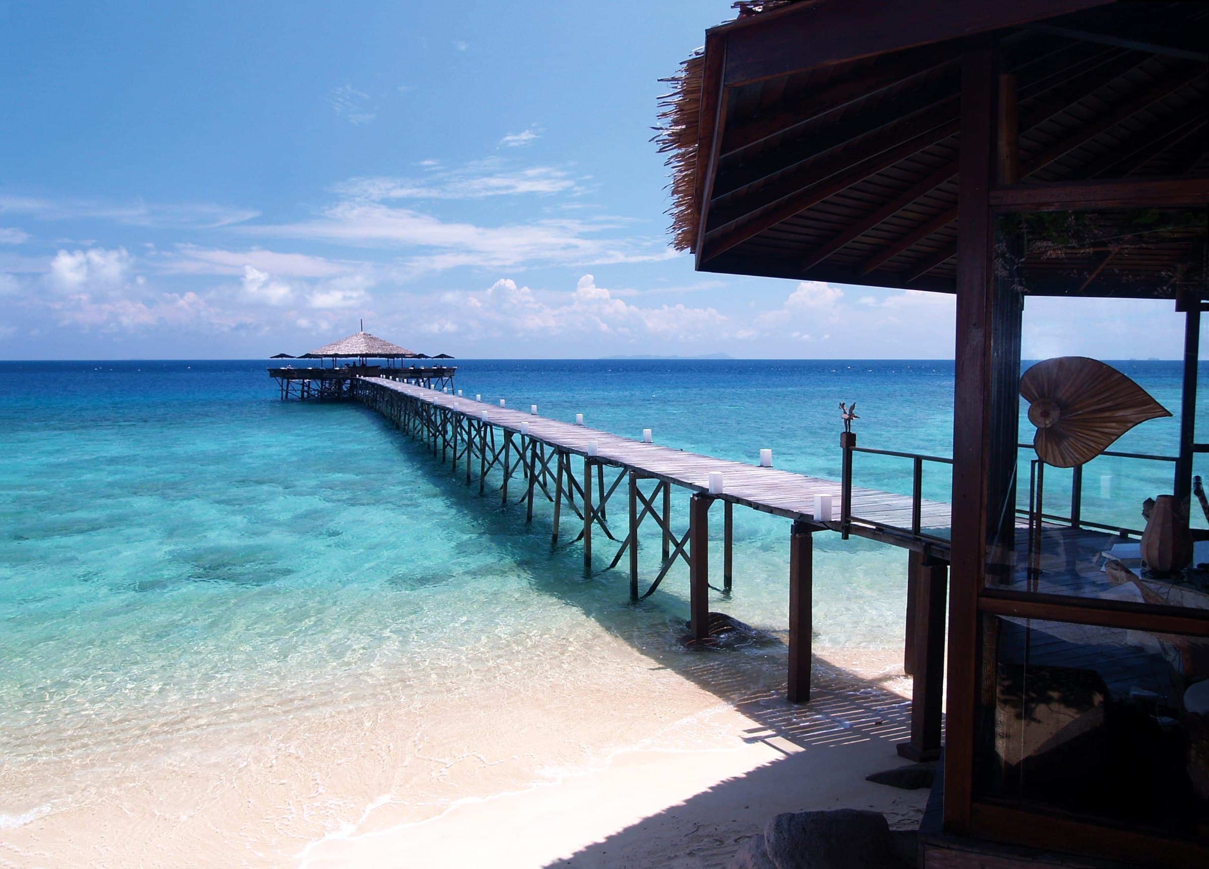 Boulder-strewn shore in golden light, Pulau Tioman